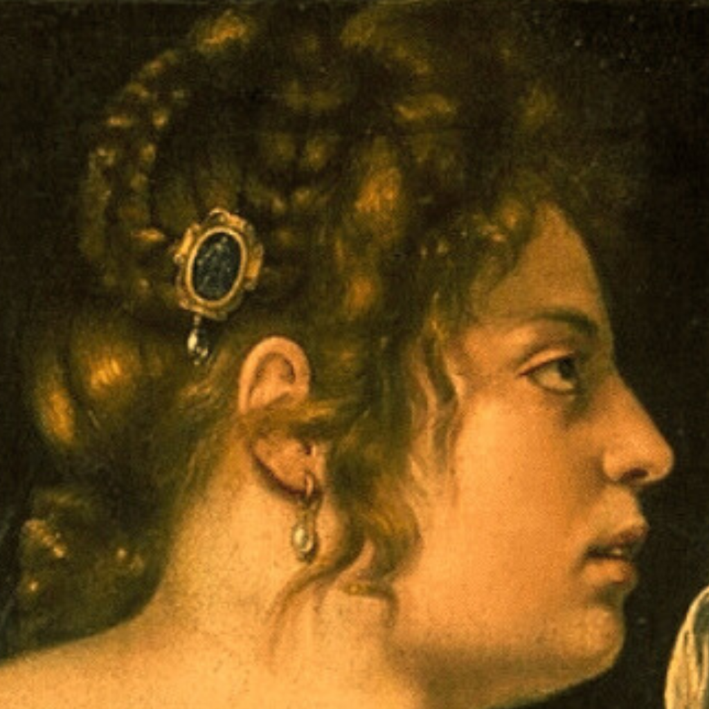 Profile view of Judith, with braided auburn hair, jeweled hairpiece, and a calm but focused expression.
