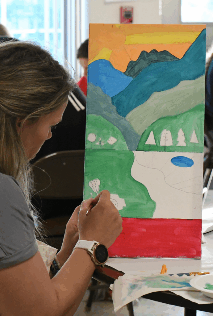 Abstract, colorful brushstrokes painted across textured canvas, representing the energy, movement, and possibility fueled by community art support.